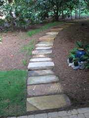custom designed stone walkway and maintained landscape