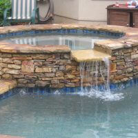 custom pool landscaping with waterfall
