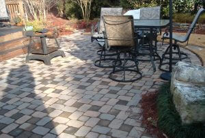 custom designed outdoor stone patio with firepit