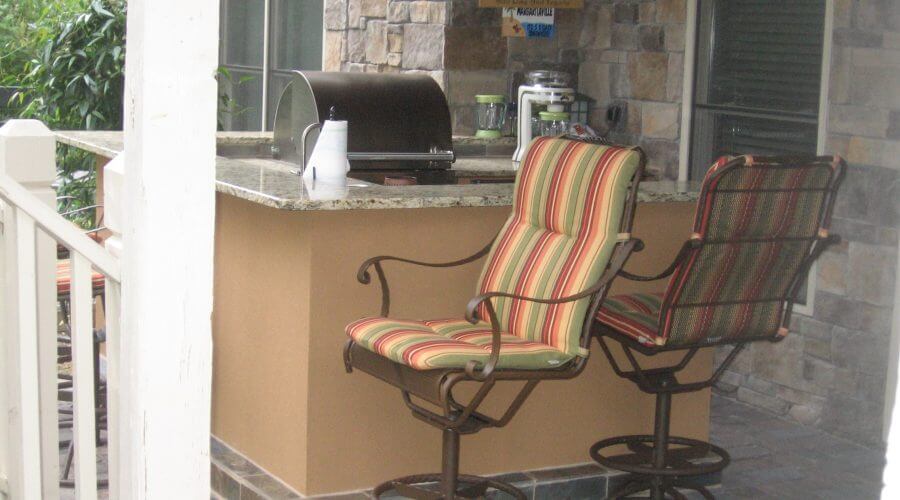 Outdoor kitchen with chairs and bar